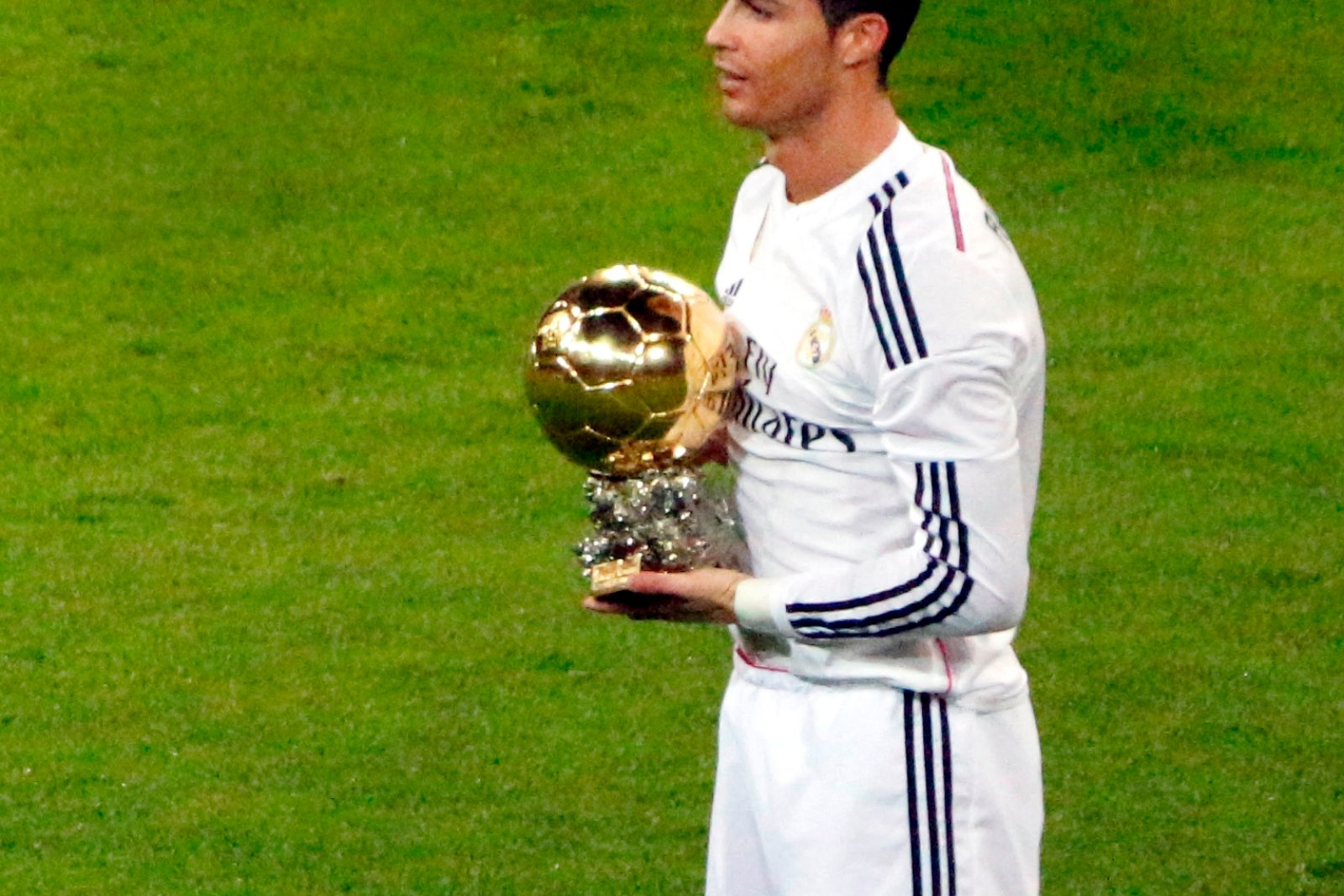 Cristiano Ronaldo holding the Ballon d’Or trophy in a Real Madrid kit